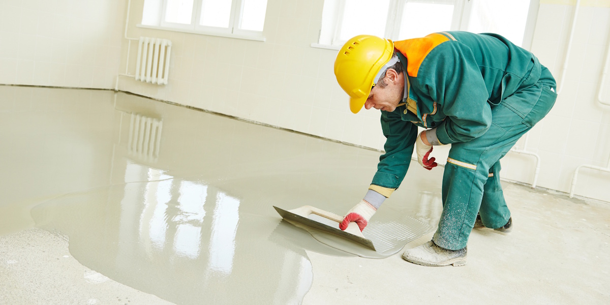 Abdichtungstechniker bringt Dichtschlämme auf Boden auf